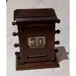 An early 20th century oak perpetual desk calendar, 17cm high, c.1920