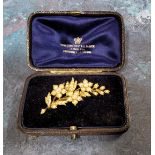 A yellow metal & seed pearl brooch in the form of a flowering branch, 7.58g in original fitted