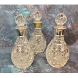 Amended description - a set of three silver mounted small whisky decanters, globular stoppers