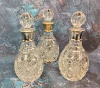 Amended description - a set of three silver mounted small whisky decanters, globular stoppers