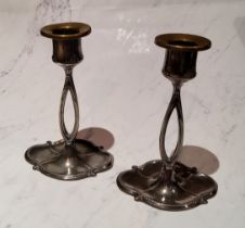 A pair of W.M.F. candlesticks, divided columns, shaped oval bases, 16cm high
