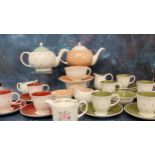 A Susie Cooper Bone China Polka Dot pattern tea for two, in peach, printed marks;  a set of five