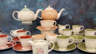 A Susie Cooper Bone China Polka Dot pattern tea for two, in peach, printed marks;  a set of five