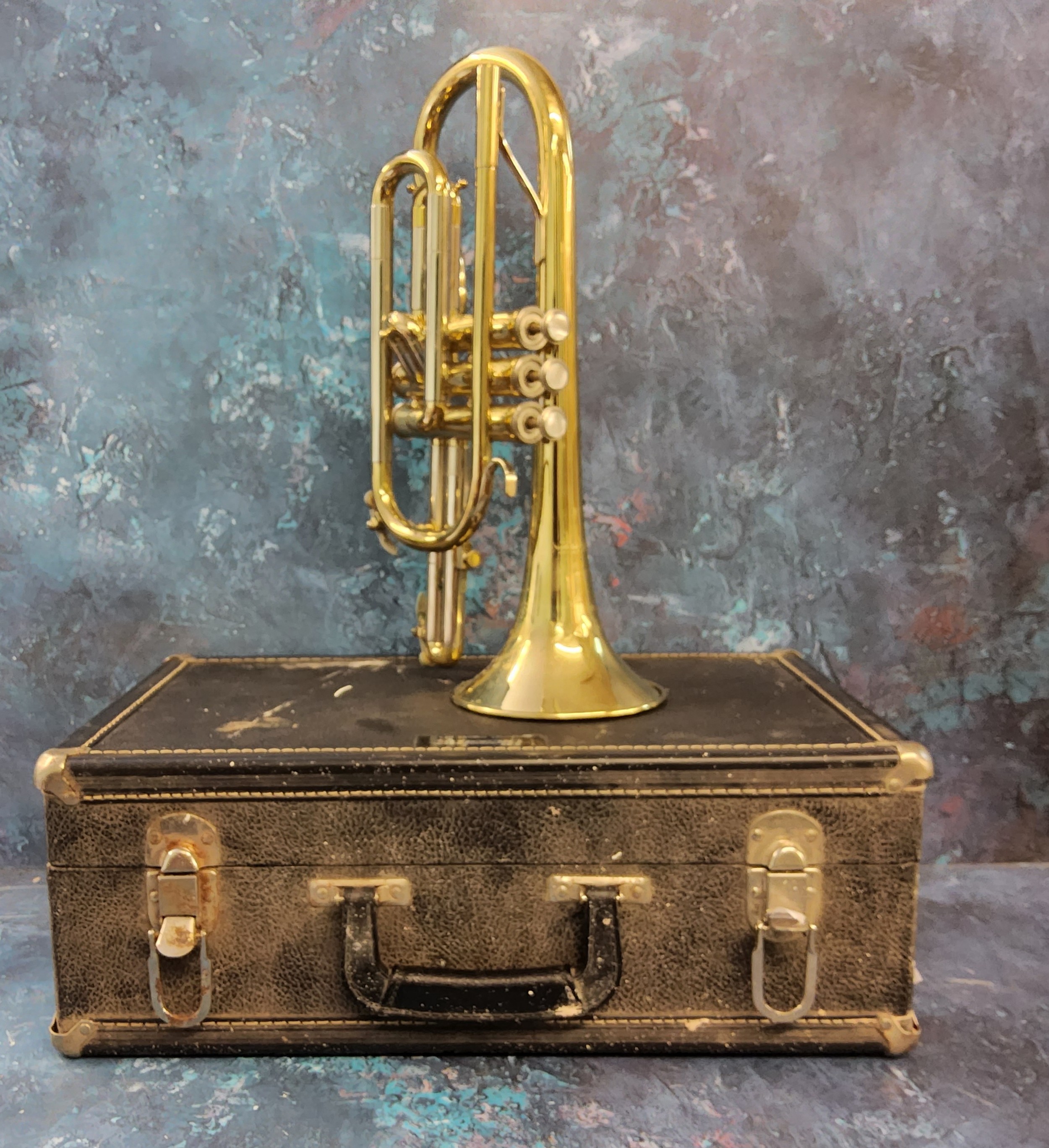 A brass trumpet, cased