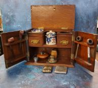 A late Victorian  smoker's cabinet, two fielded panelled doors, the interior with tobacco jar,