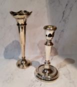 A silver table candlestick, reel shaped sconce, tapering column, dished circular base, 16.5cm