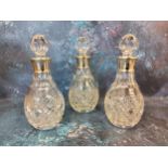 A set of three silver mounted  decanters, globular stoppers, 21cm high,  James Dixon & Sons,