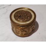 An early 20th century Palais Royal musical circular bijouterie box, the cover set with figures and
