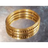 A Victorian yellow gold Etruscan style hinged bangle, 16.19g