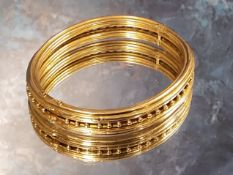 A Victorian yellow gold Etruscan style hinged bangle, 16.19g