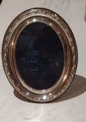 A silver oval easel photograph frame, 16cm high, 13.5cm wide, Sheffield 1988