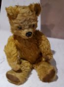 An English jointed mohair bear, stitched nose and mouth, velveteen pads, 47cm high, c.1930
