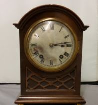 A late 19th century mahogany mantel clock, with Roman numerals, twin winding holes, eight day