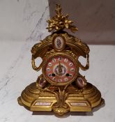 A French gilt metal mantel clock, H T Brevet,  set with porcelain panels, Roman numerals, twin