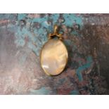 A 9ct gold mounted two-sided oval fob/pendant set with mother of pearl & moss agate approx. 4.5 x