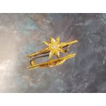 A 15ct gold & diamond bar brooch, the bar surmounted with an eight-pointed star, set with an old cut