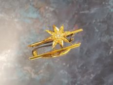 A 15ct gold & diamond bar brooch, the bar surmounted with an eight-pointed star, set with an old cut