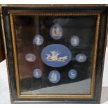 A set of nine 19th century oval Wedgwood blue jasper cameos, various sizes, framed as one