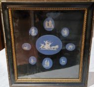 A set of nine 19th century oval Wedgwood blue jasper cameos, various sizes, framed as one