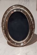 A silver oval easel photograph frame, 16cm high, 13.5cm wide, Sheffield 1988