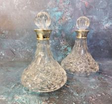 A pair of silver mounted decanter, globular stoppers, 28cm high,  James Dixon & Sons, Birmingham,