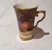 An English porcelain mug, painted Marian Greaves, with ripe fruit on a mossy bank, picked out in