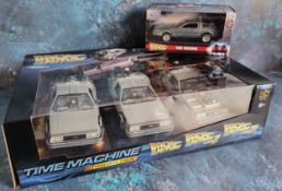 A Welly Back to the Future Time Machine Trilogy pack 1:24 scale, comprising of Doloreans from Back