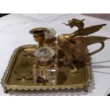 A  brass wyvern inkstand, of rounded square form, with two wells, the wyvern with wings