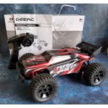 A DEERC 9206E 4WD 1:10 scale Remote Control Truck with an extra clear shell, built, with contoller