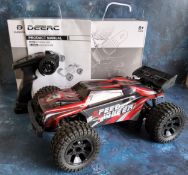 A DEERC 9206E 4WD 1:10 scale Remote Control Truck with an extra clear shell, built, with contoller