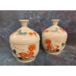 A pair of Chinese Rouge De Fer bowls and covers, decorated in the typical palette with Dogs of Fo,