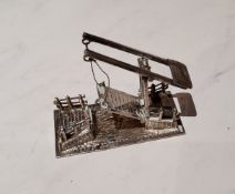 A Dutch silver coloured metal miniature model of a bridge, 5cm wide