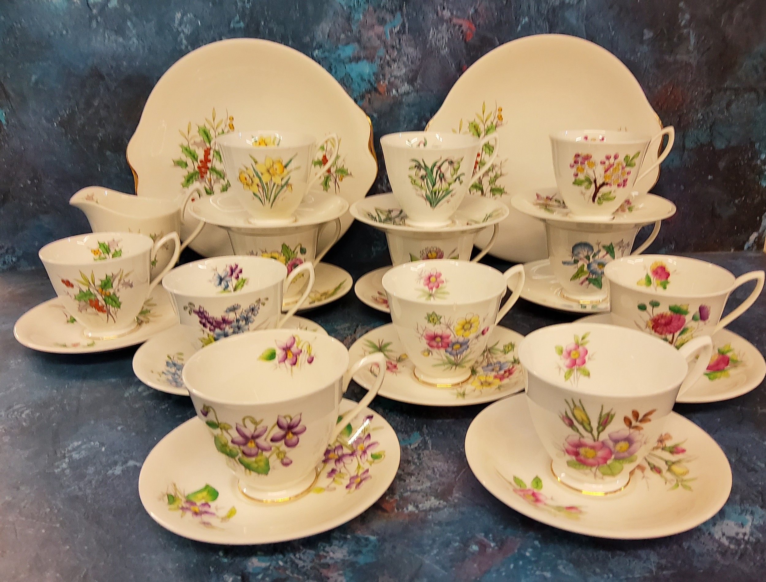 A Royal Albert Holly pattern teacup and saucer, milk jug and two bread and butter plates, printed