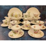 A Royal Albert Holly pattern teacup and saucer, milk jug and two bread and butter plates, printed