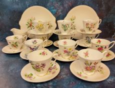 A Royal Albert Holly pattern teacup and saucer, milk jug and two bread and butter plates, printed