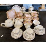 A Tuscan tea service, for six, decorated with flowers on a pink ground, printed marks;   another,