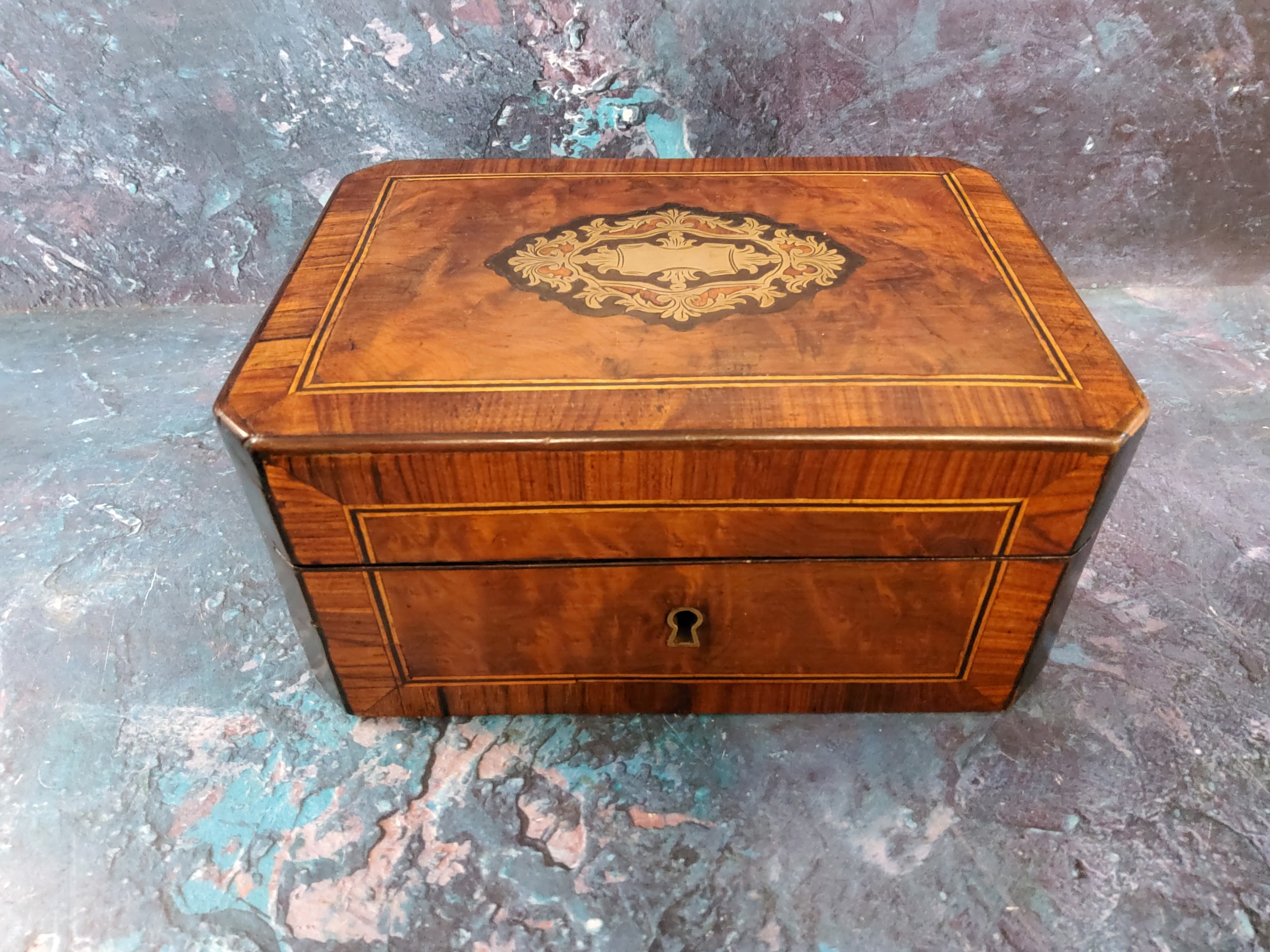 A 19th century French walnut canted rectangular jewellery box, the cover inlaid with brass