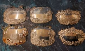 A silver cartouche shaped decanter labels, Sherry;  others, plated cast with sporting pursuits;  etc