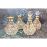 Two silver collared cut glass small decanters, globular shaped cut glass stopper, 21.5cms high,