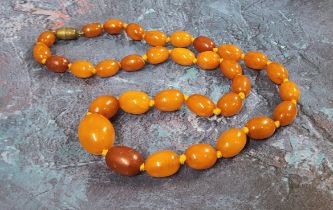 A string of graduated butterscotch amber beads, 50cms, 30.44g gross