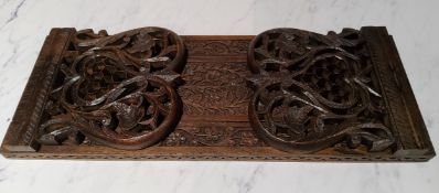 An Anglo Indian hardwood book slide, pierced and carved, 35cm long
