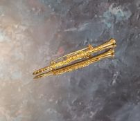 A 9ct gold novelty brooch in the form of a clarinet, JS, Sheffield, 5.31g (VAT on Hammer price)
