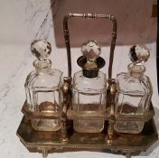 A plated three bottle tantalus, canted square bottles, swing handle, 37cm wide
