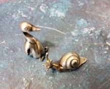 A silver miniature toy, of a goose, 3cm high, 925;  another as a snail, 3.25cm wide (2)