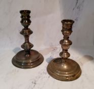 A silver table candlestick, reel shaped sconce, knopped column, dished circular base, 15cm high,