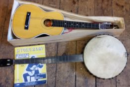 A four-string banjo; Kapok Brand guitar shaped ukulele (2)