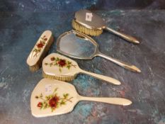 A silver three piece dressing table set, decorated with roses, Birmingham 1959;  a silver backed