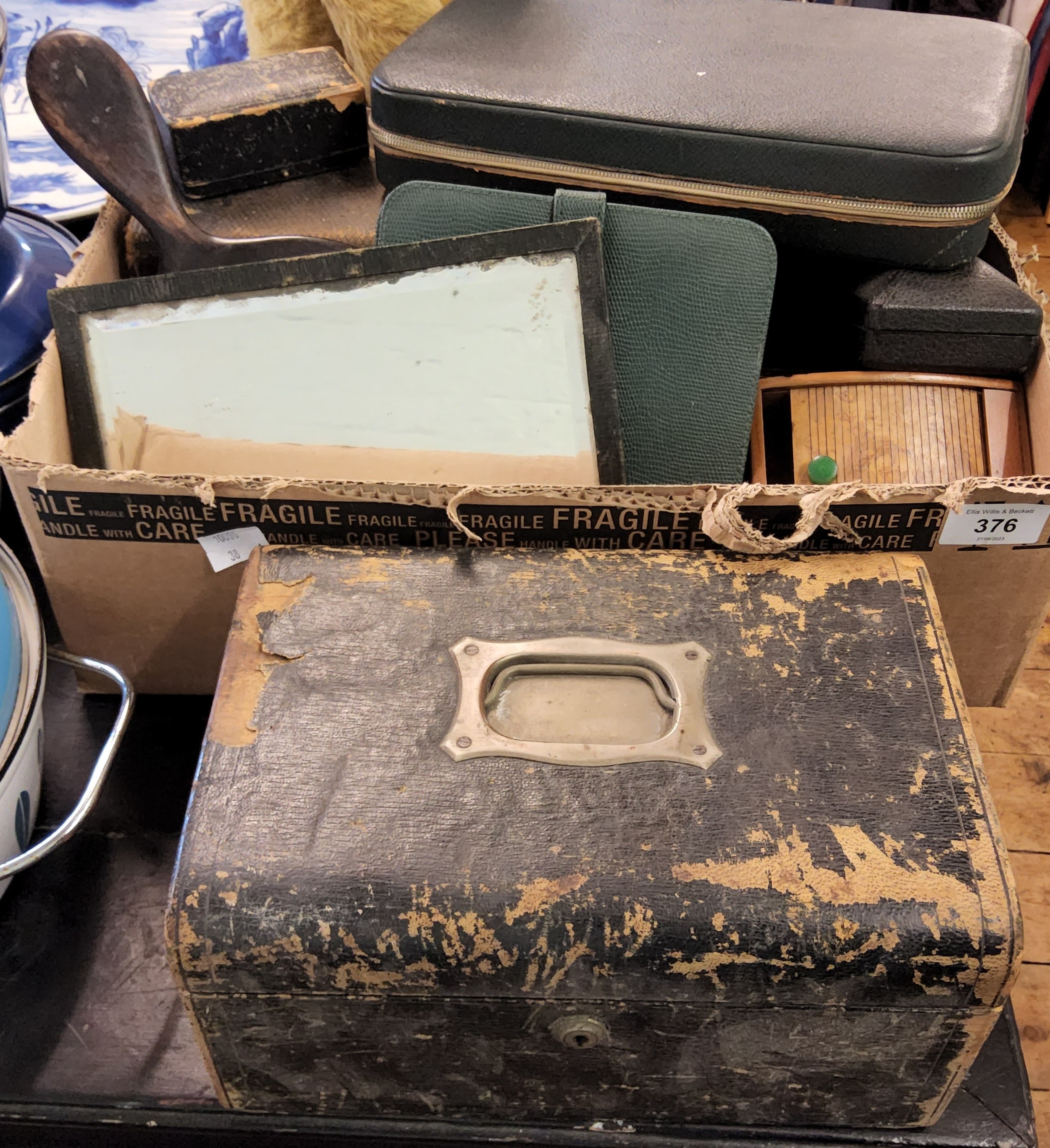 A green leather bound jewellery box, fitted interior; others; jewellery trays; an ebony hand mirror;