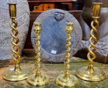 A pair of 19th century open twist brass candlesticks, another pair twisted, the largest pair