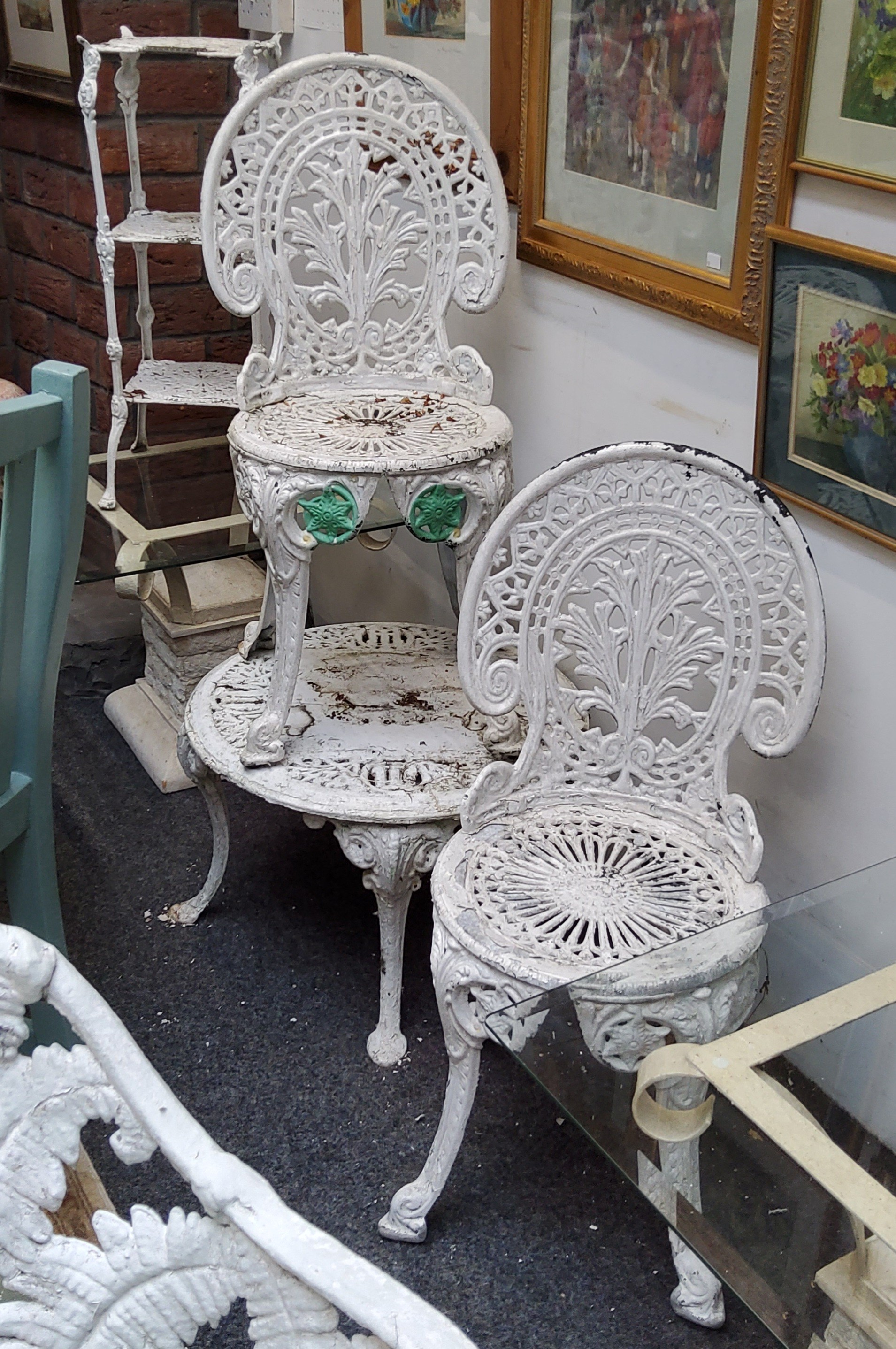 A pair of Coalbrookdale style garden seats, coffee table and three tier cake stand, painted with